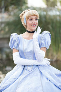 A Cinderella performer interacting with children at a themed birthday party.