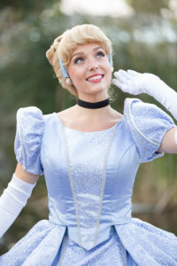 Cinderella-inspired princess twirling in a grand ballroom with elegant decor.