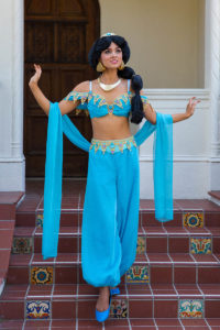 A Jasmine performer leading children in a themed dance activity.