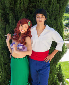 Ariel dancing with a group of kids in a decorated party room with under-the-sea-themed balloons in Orange County.
