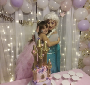 A table setup with princess-themed party favors and decorations.