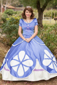 A Princess Sofia performer interacting with children at a themed birthday party.